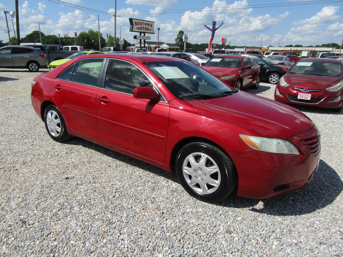 2007 Red /Tan Toyota Camry (4T1BK46K97U) with an 4 CYL engine, Automatic transmission, located at 15016 S Hwy 231, Midland City, AL, 36350, (334) 983-3001, 31.306210, -85.495277 - Photo#0